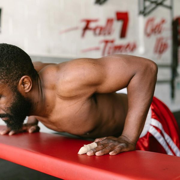 Man in a focused state, preparing for a bodyweight exercise.